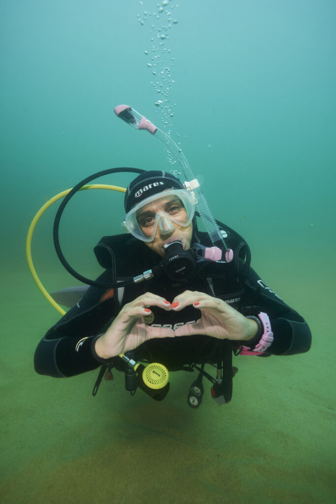 Diver making a heart sign with her hands