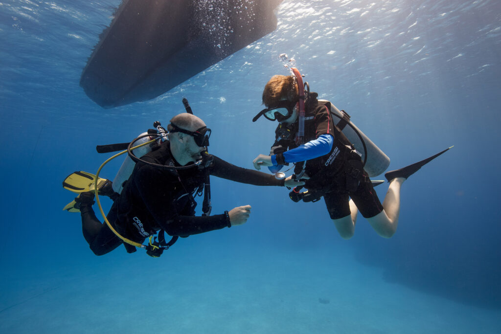 Child and instructor diving in Grand Cayman