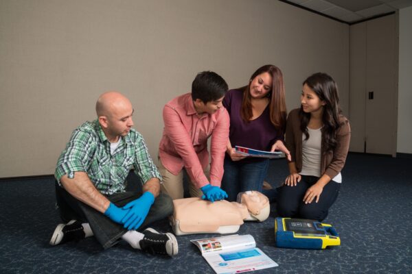 Group of individuals practicing EFR on mannequin