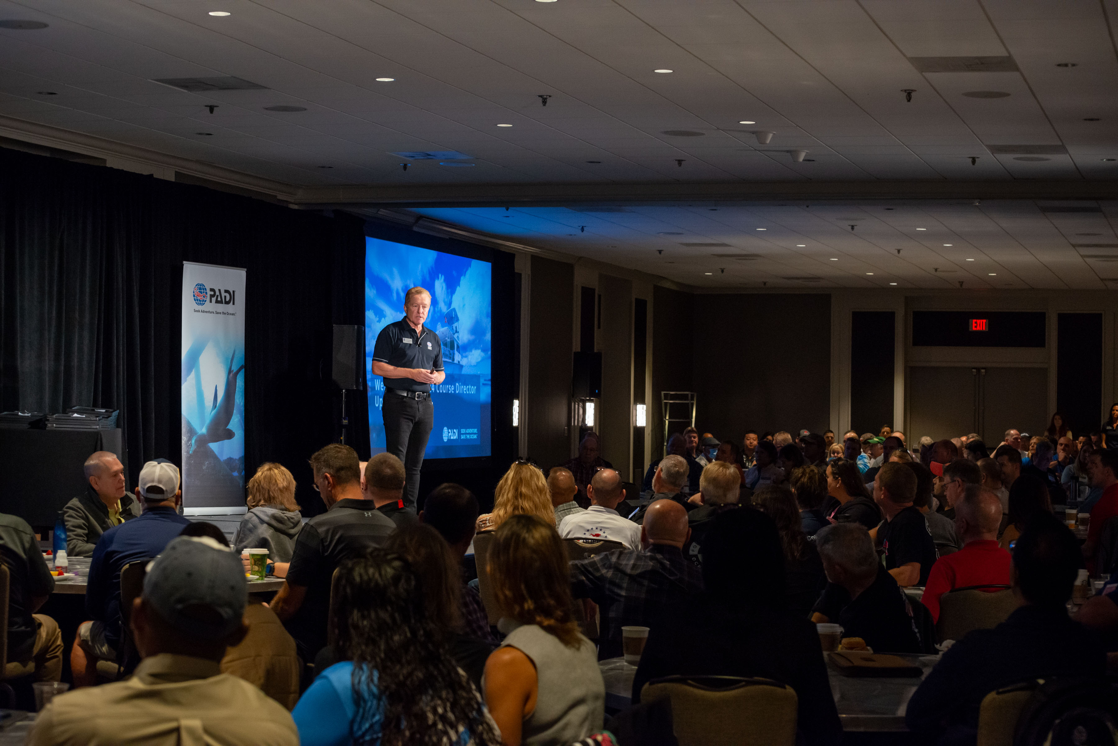 Speaker on a stage for the Course Director Update for DEMA 2023 in New Orleans