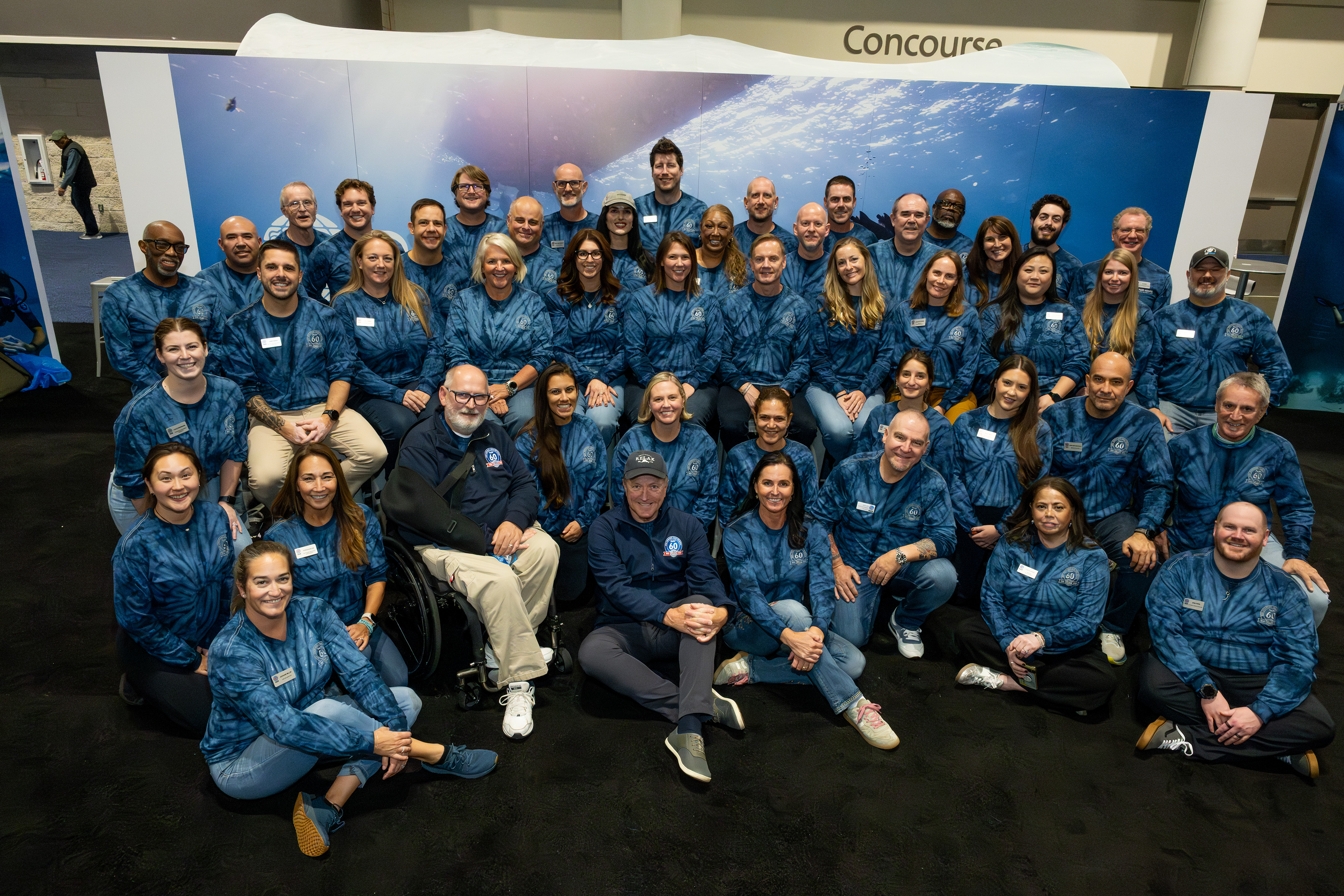 Group photo with 3 rows of people for DEMA 2025