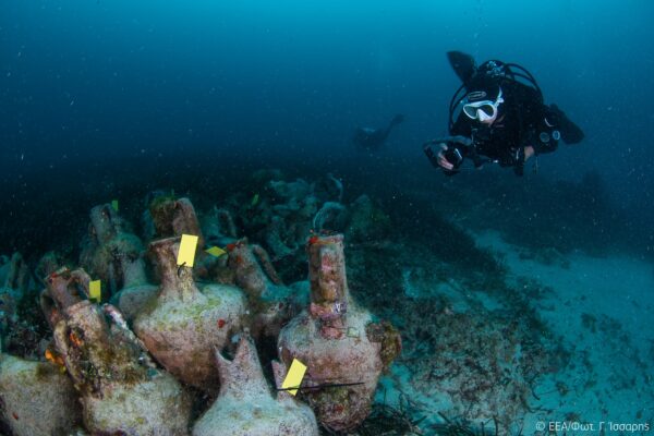 a diver photographs an ancient shipwreck in Greece
