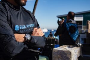 a person wearing a PADI AWARE rashguard