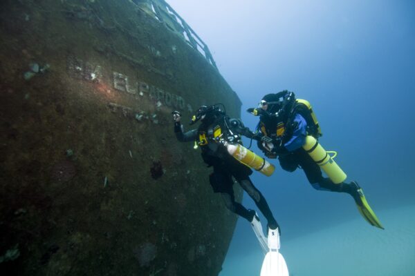 two rebreather divers explore a shipwreck