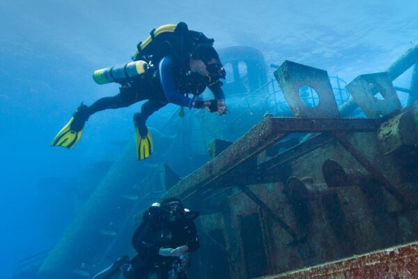 two rebreather divers explore a wreck