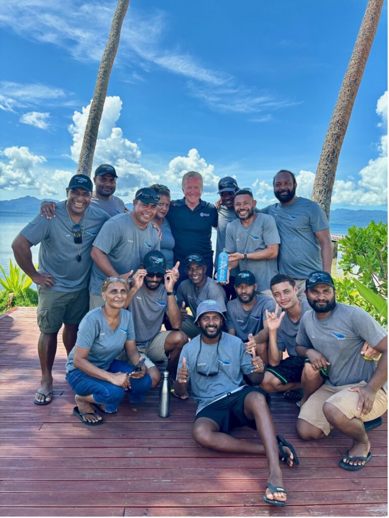 PADI CEO and President Drew Richardson presents Dive Manager Danny Lomani and the amazing dive team at Jean-Michel Cousteau Resort with their 30-year award.