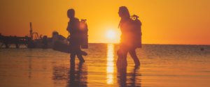 two women walk out of the water after a shore dive