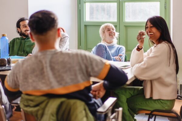 students laugh around a table