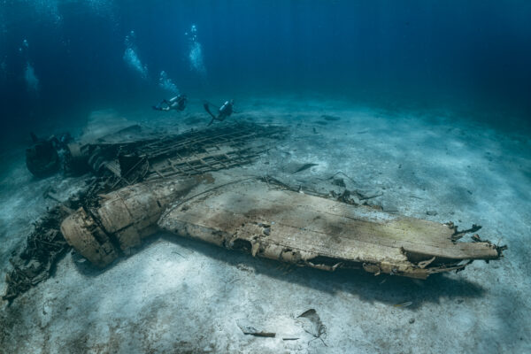 two divers explore a plane wreck in the Bahamas
