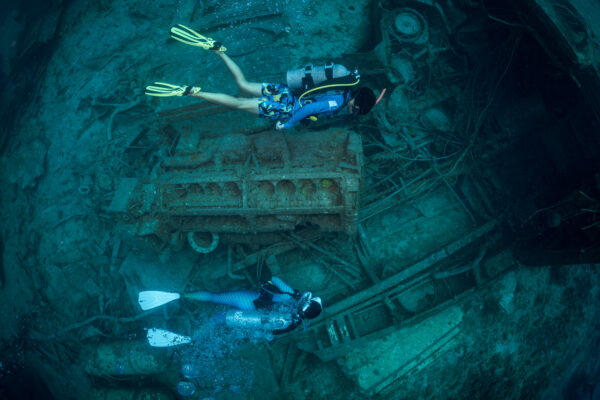 two diver explore a wreck in the Bahamas