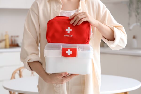 A woman holds a first aid kit