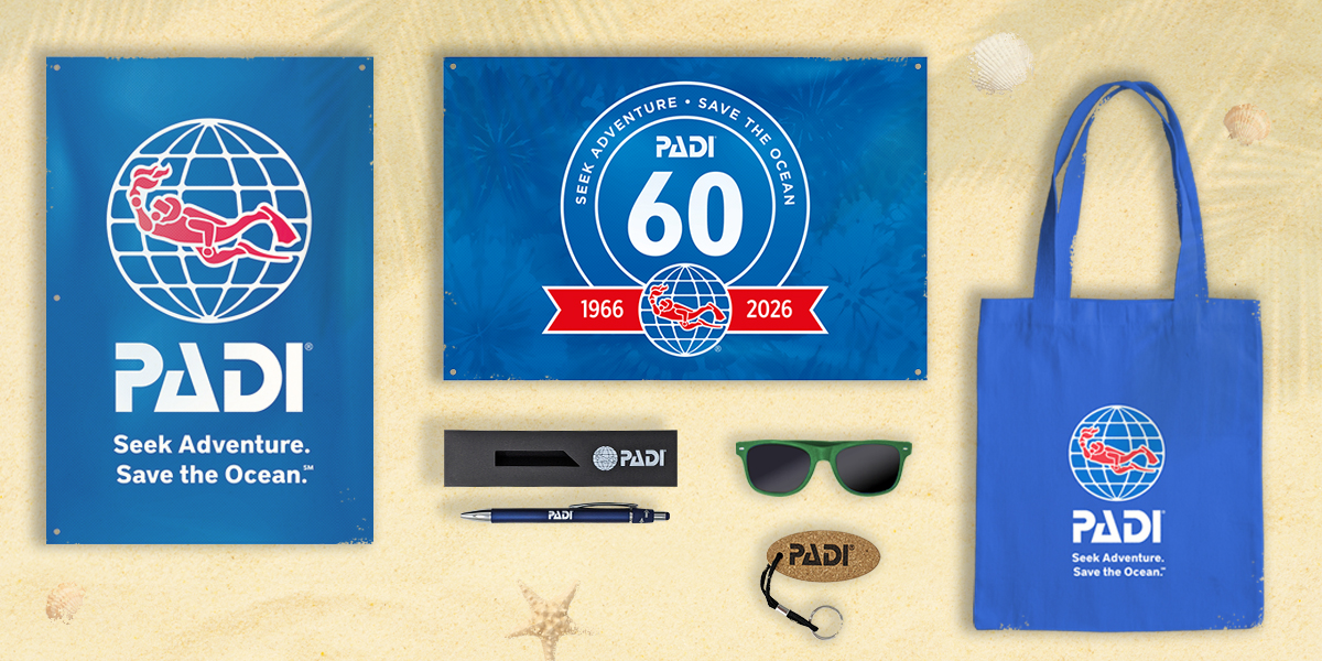 Photo of all the PADI branded goods included in the 2026 60th anniversary renewal packs, including