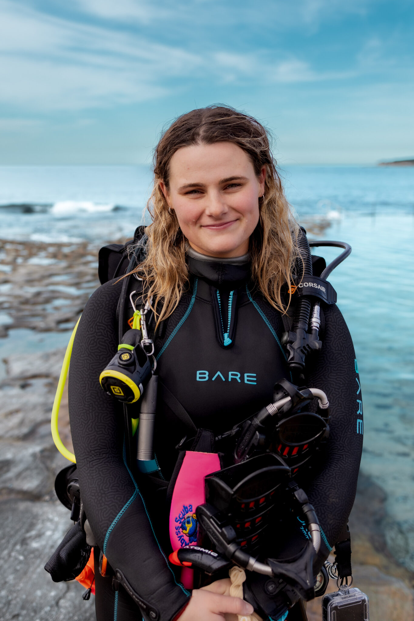 PADI OWSI Jessica Hill standing in her wetsuit in front of the ocean in Australia