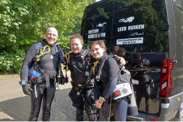Pascal Cantaert with two students all geared up in front of the dive shop van