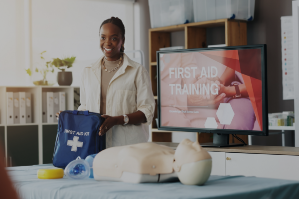 A woman teaches a CPR course with a dummy